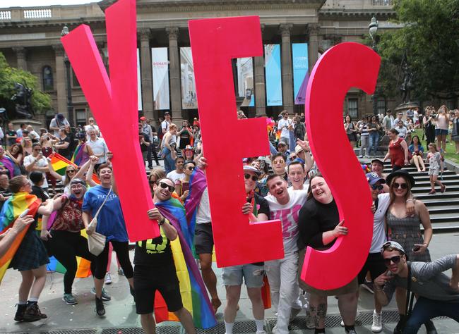 People celebrate after the announcement of the same-sex marriage postal survey result in front of the State Library of Victoria in Melbourne, Wednesday, November 15, 2017. Picture: AAP Image/David Crosling