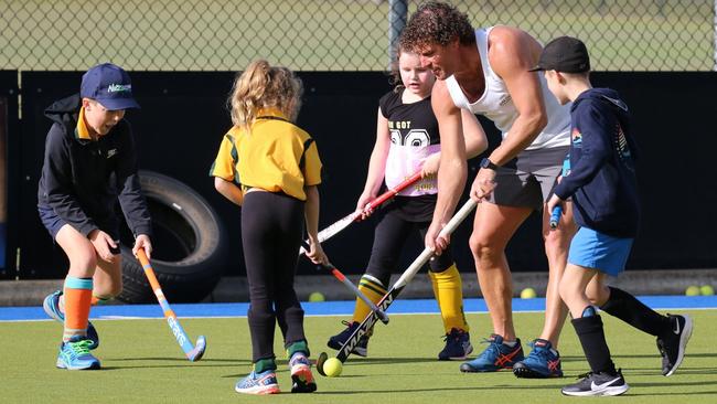 Grafton hockey legend Brent Livermore joined juniors during a school holiday hockey clinic at the Grafton fields on Thursday. Photo: Suellen Jenkins