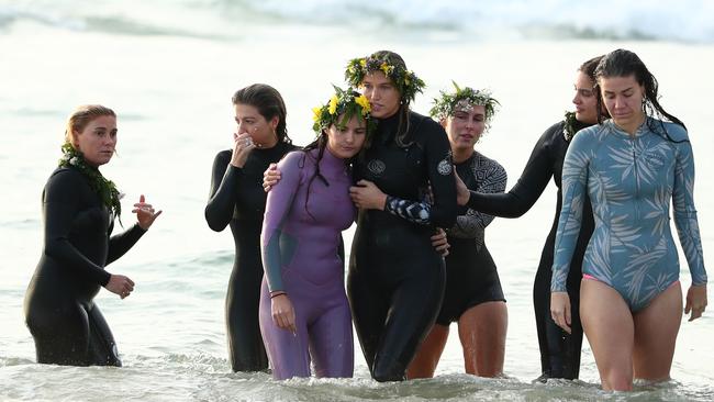 Alex Pullin's girlfriend Ellidy Vlug is supported by family and friends at a paddle out in his memory at Palm Beach on Saturday. (Photo by Chris Hyde/Getty Images)