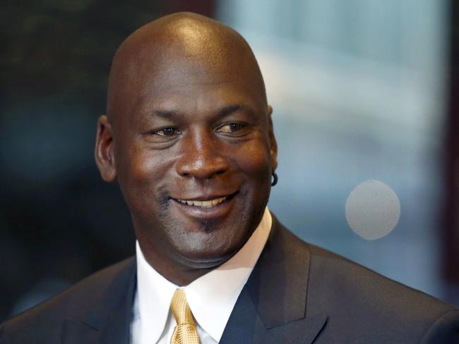 FILE - In this Aug. 21, 2015, file photo, former NBA star and current owner of the Charlotte Hornets, Michael Jordan smiles at reporters in Chicago. A quarter century after being famously excluded from the cult favorite video game NBA Jam, Jordan is investing in esports. Jordan on Thursday, Oct. 25, 2018, was announced as an investor with aXiomatic, a major esports ownership group whose properties include powerhouse franchise Team Liquid. (AP Photo/Charles Rex Arbogast, File)