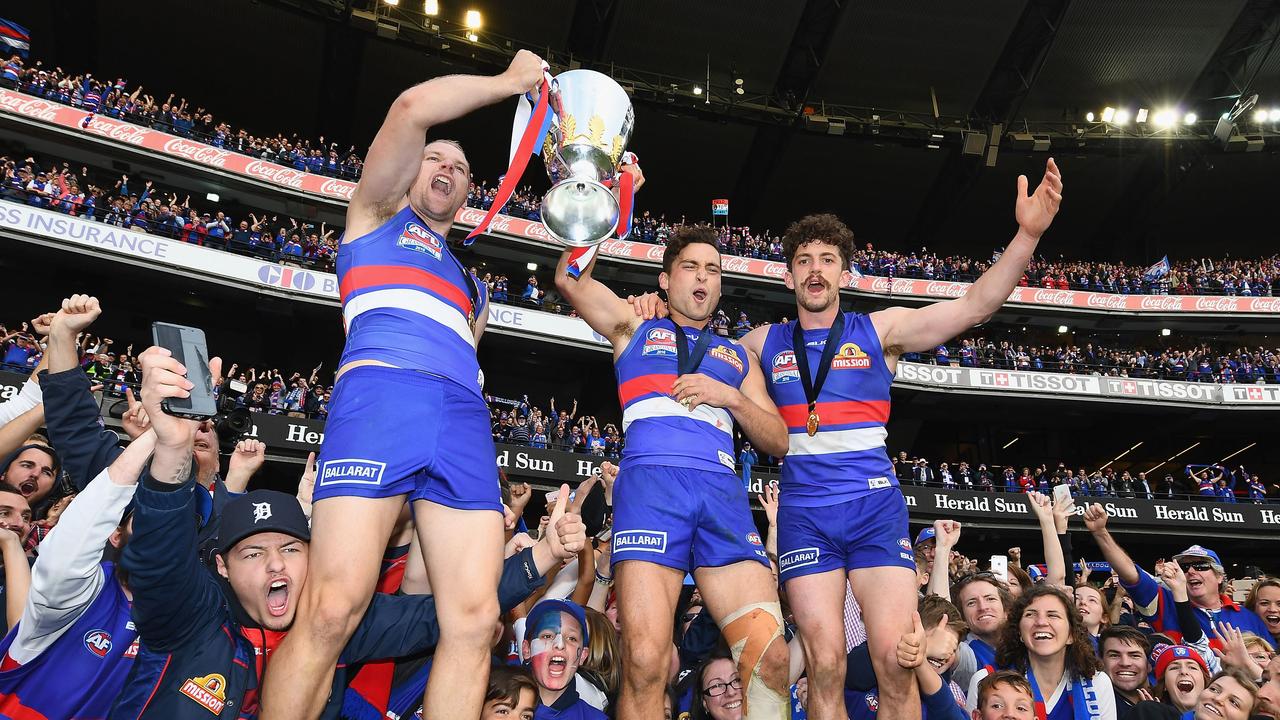 Jake Stringer, Luke Dahlhaus and Tom Liberatore celebrate the Western Bulldogs’ drought-breaking Grand Final win in 2016. Picture: Quinn Rooney/Getty Images.