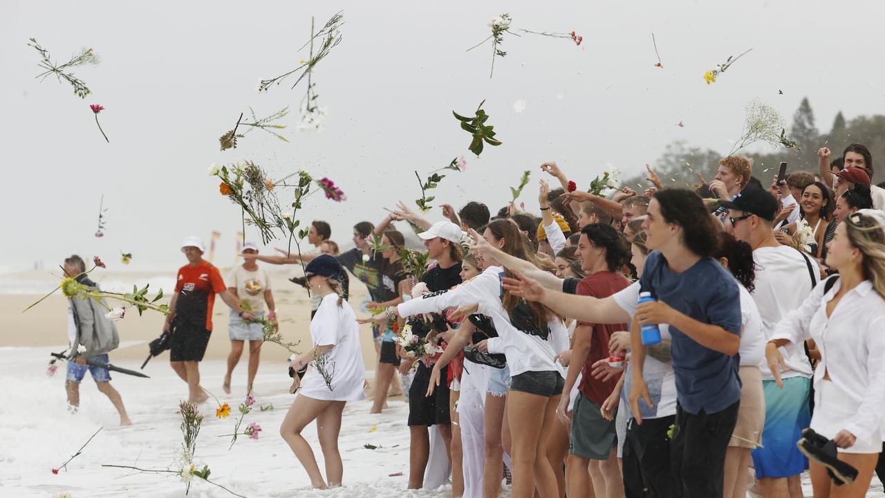 Family and friends of 16-year-old alleged stabbing victim Balin Stewart gather to pay tribute on his home beach at Buddina. Picture: Lachie Millard