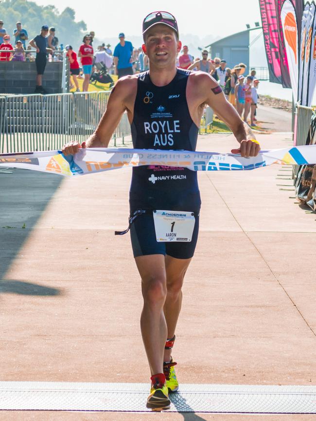 Male winner of the triathlon Aaron Royle crosses the finish line. (JGRimages)