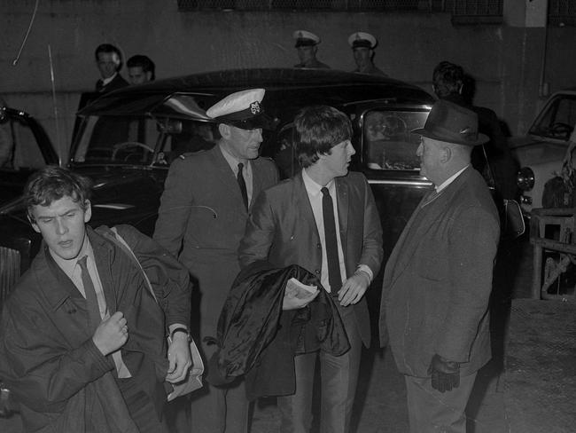 Paul McCartney a member of the Pop Group the Beatles talking with policeman as after arriving at Lennons Hotel Brisbane. Picture: News Corp