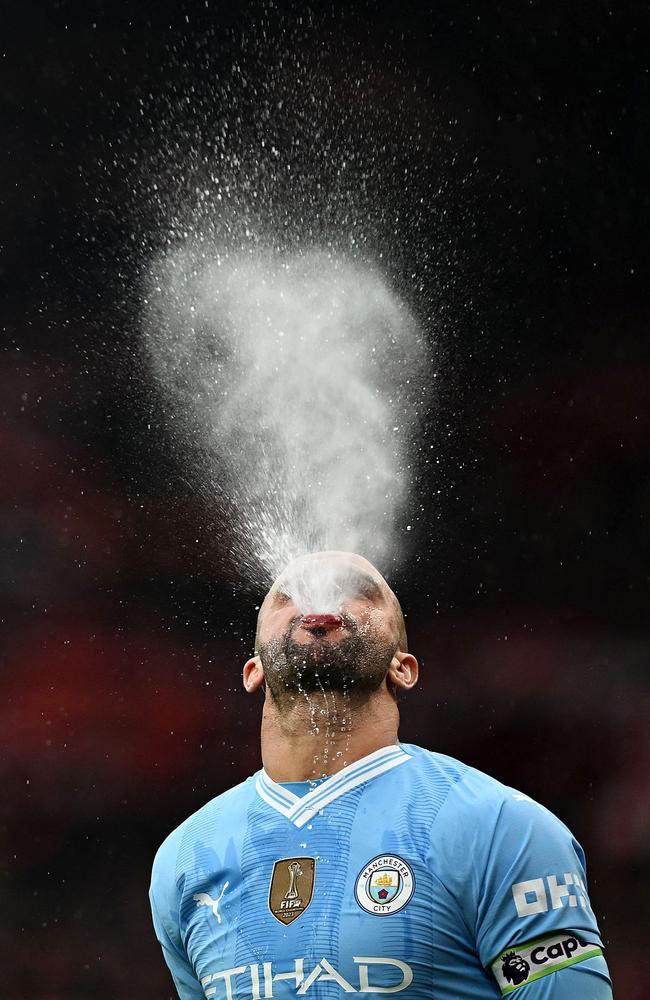 Manchester City's defender Kyle Walker pours water over his face before spitting it out, ahead of the English Premier League football match against Liverpool. Picture: Paul Ellis/AFP