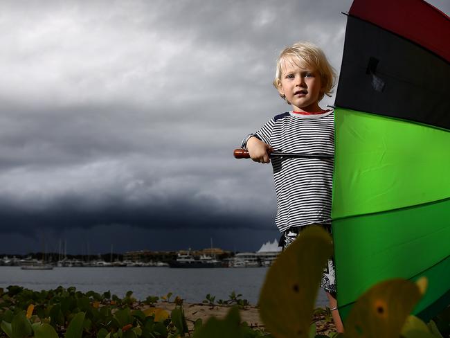 Heavy rain is forecast for the next couple of days and 2 year old James Adsett gets prepared on the Gold Coast as storms roll in (0431503334). Pics Adam Head