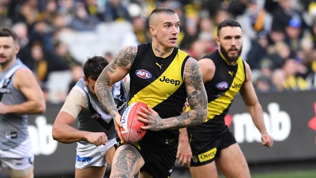 Dustin Martin of the Tigers (second from right) is seen in action during the Round 18 AFL match between the Richmond Tigers and the Port Adelaide Power at the MCG in Melbourne, Saturday, July 20, 2019. (AAP Image/Julian Smith) NO ARCHIVING, EDITORIAL USE ONLY