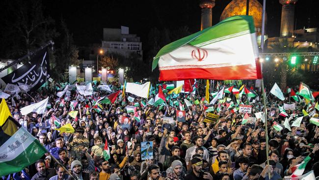 Demonstrators gather with Iranian and Palestinian flags and the yellow flags of the Lebanese Shiite movement Hezbollah during a protest in Tehranon Friday amid the ongoing battles between Israel and the Palestinian group Hamas. Picture: AFP