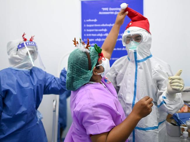 Health workers combined Christmas accessories with personal protective equipment in the Intensive Care Unit at Ayeyarwady Covid Centre in Mandalay, Myanmar. Picture: Ye Aung Thu/AFP