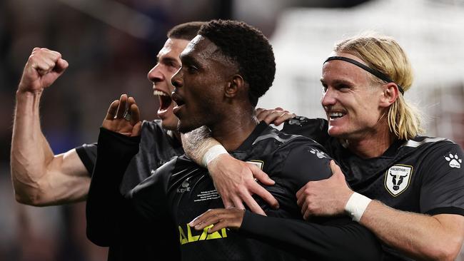 Macarthur FC’s Al Hassan Toure celebrates scoring a penalty with teammates during the Australia Cup final. Picture: Cameron Spencer/Getty Images