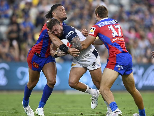 Sam McIntyre of the Cowboys is tackled during the round two NRL match between North Queensland Cowboys and Newcastle Knights at Qld Country Bank Stadium, on March 16, 2024, in Townsville, Australia. (Photo by Ian Hitchcock/Getty Images)