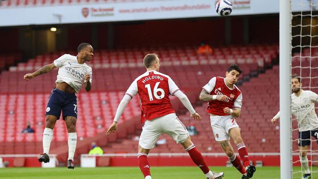Raheem Sterling heads the ball into the net to give Man City victory over Arsenal