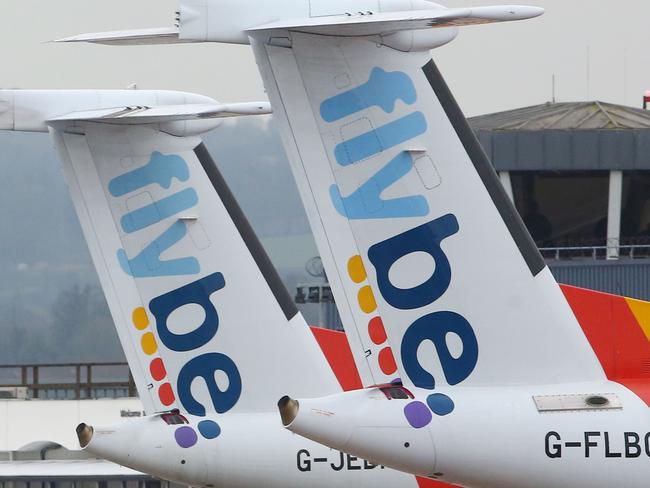 Flybe aircraft are pictured on the tarmac at Exeter airport in Exeter, south-west England on March 5, 2020, following the news that the airline had collapsed into bankruptcy. - British regional airline Flybe crashed into bankruptcy Thursday after the deadly coronavirus proved to be the final nail in its coffin. The biggest operator of UK domestic flights said it has sunk into administration -- a last-ditch process aimed at salvaging at least some of the company. (Photo by GEOFF CADDICK / AFP)