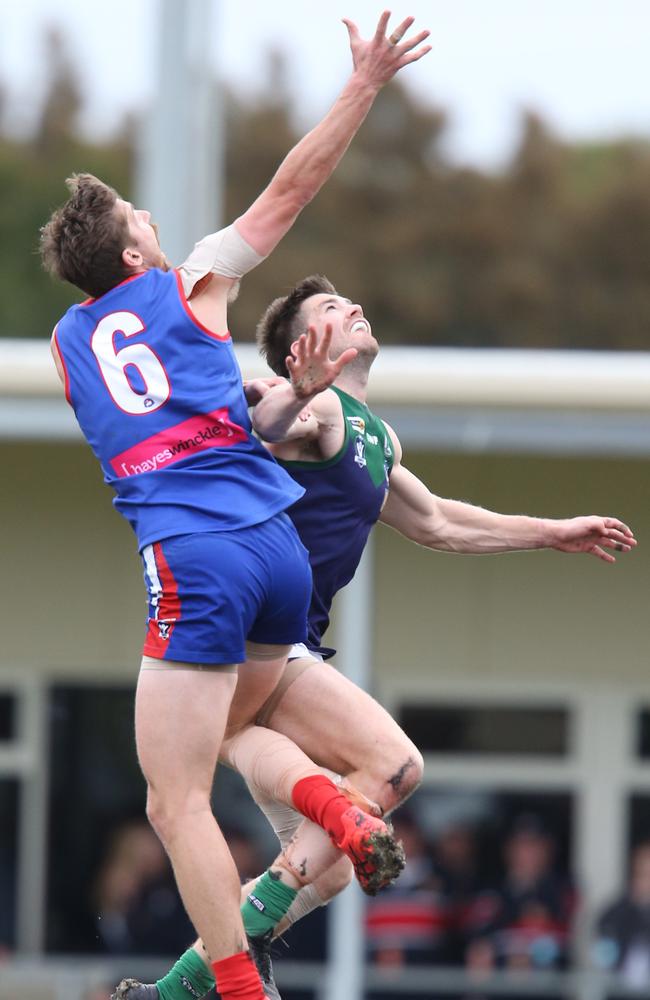 South Barwon’s Luke Davis takes a leap over St Mary's Nick Nott. Picture: Mark Wilson