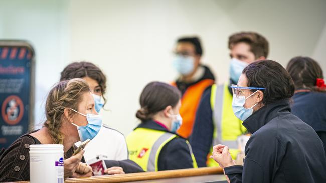 Arrivals into Hobart Airport going through Covid screening procedures with Biosecurity Tasmania. Picture: Mathew Farrell