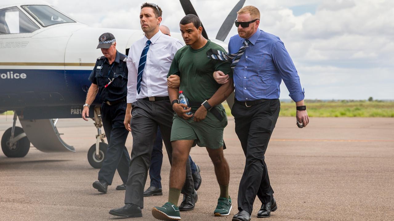 Jermaine Austral is escorted by police upon his return to Alice Springs after breaking out of the prison days before Christmas 2016. Photo: EMMA MURRAY