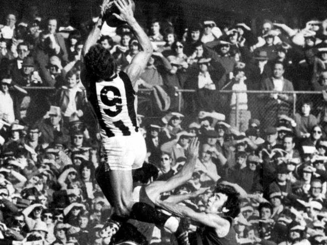Phil Carman soars to take a big mark against Melbourne in 1976.