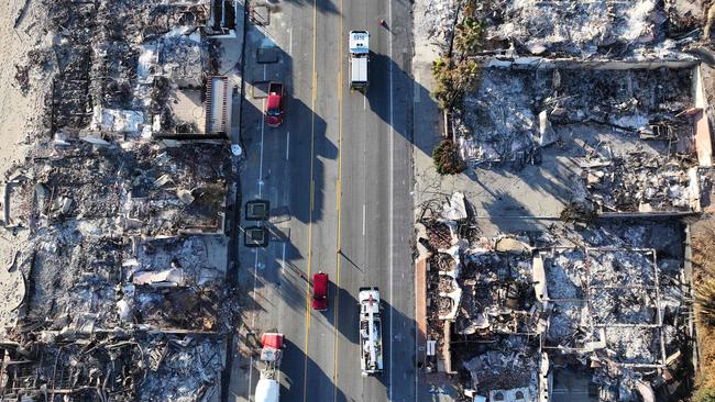 An aerial view of a fire truck driving past beachside homes in Malibu destroyed in the Palisades fire. Picture: Getty Images