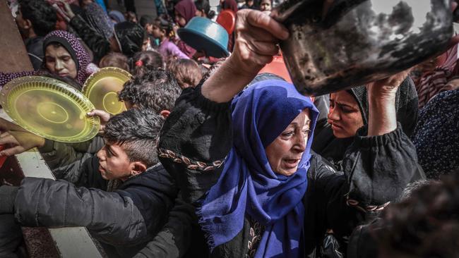 Displaced Palestinians gather to receive food at a government school in Rafah in the southern Gaza Strip. Picture: AFP