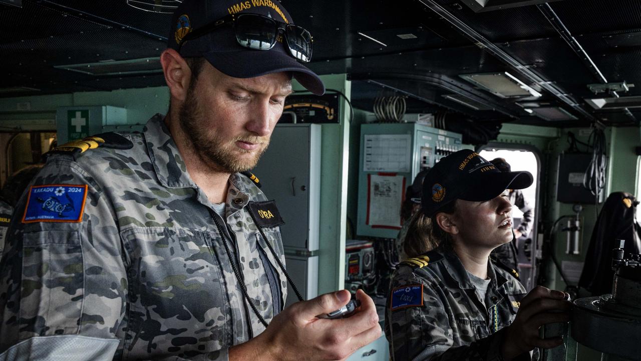 HMAS Warramunga Navigation Officer, Lieutenant Ryan O'Hara directs the ships during a photography exercise. Picture: Department of Defence.