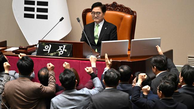 People Power Party politicians (bottom) argue with speaker Woo Won-shik during the impeachment vote of acting president Han Duck-soo. Picture: Jung Yeon-je/AFP