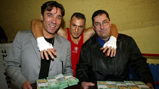 Kick Boxer Jenk "The Great White Shark" Behic (in the middle) fighting for $200,000.00 against Mike Zambidis on August 8, 2002. Managers Tarik Solak and Mike Vukovic hold the money.