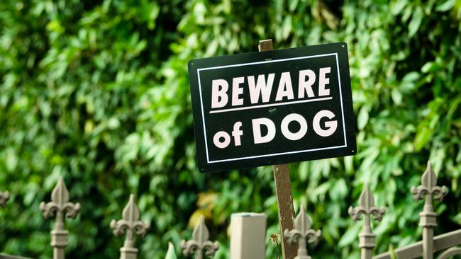 "A sign that says ""Beware of Dog"""