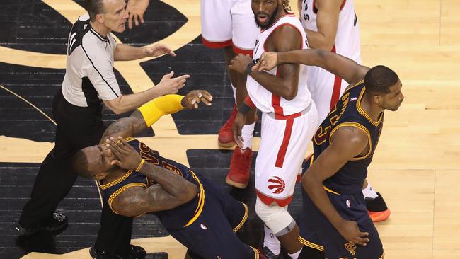 LeBron James of the Cleveland Cavaliers reacts after being hit in the face by teammate Tristan Thompson.