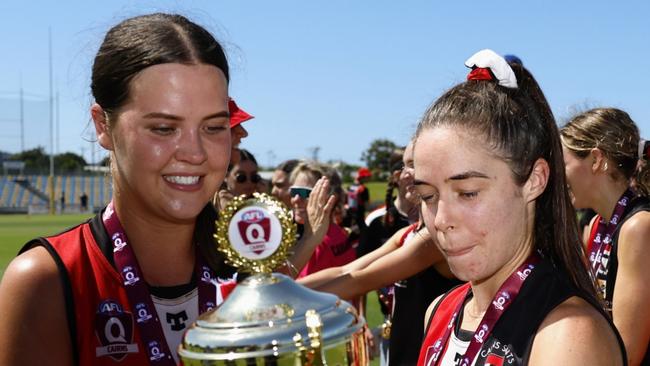 The Cairns Saints' Best on Ground Grace Perry and captain Kate Fowles celebrate winning the 2022 AFL Cairns women' premiership, defeating the Cairns City Lions in the grand final match at Cazalys Stadium. Picture: Brendan Radke