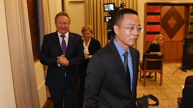 Long Zhou (centre) departs the press conference followed by Andrew Forrest. Picture: AAP.