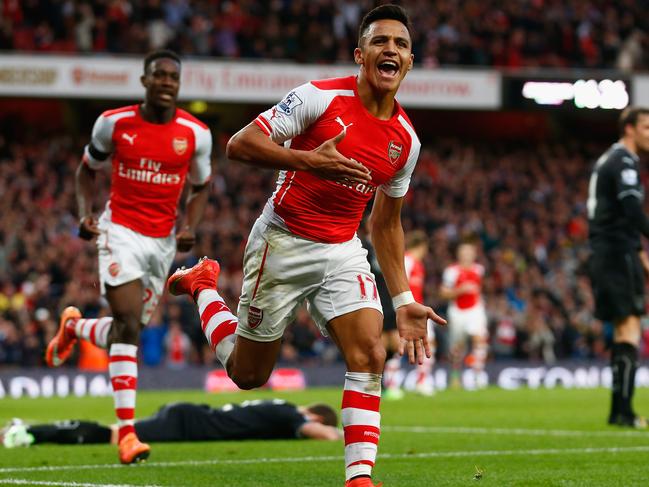 LONDON, ENGLAND - NOVEMBER 01: Alexis Sanchez of Arsenal celebrates scoring the third goal for Arsenal during the Barclays Premier League match between Arsenal and Burnley at Emirates Stadium on November 1, 2014 in London, England. (Photo by Julian Finney/Getty Images)