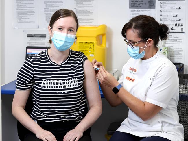 Courtney Mawn from Coorparoo getting their flu jab from Pharmacist Amanda Seeto. Picture: Steve Pohlner