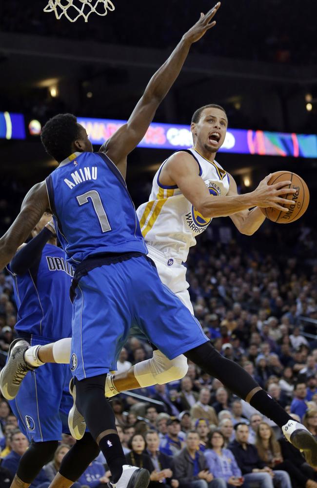 Golden State Warriors' Stephen Curry, right, looks for a shot past Dallas Mavericks' Al-Farouq Aminu.