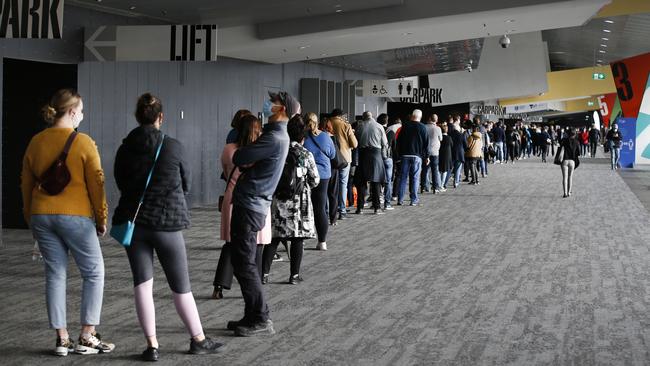 Crowds at Melbourne Exhibition and Convention Centre line up to get the jab. Picture: David Caird