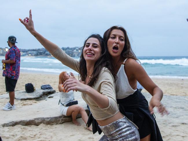 People dancing at Bondi Beach early on New Year’s Day. Picture: Jenny Evans/Getty