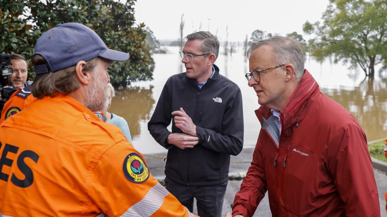 The Prime Minister shakes hands with State Emergency Service workers on his tour of flood-affected areas. Picture: Jenny Evans/Getty Images