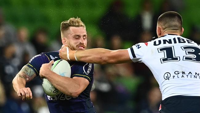 MELBOURNE, AUSTRALIA - APRIL 16:  Cameron Munster of the Storm is tackled high by Victor Radley of the Roosters during the round six NRL match between the Melbourne Storm and the Sydney Roosters at AAMI Park on April 16, 2021, in Melbourne, Australia. (Photo by Quinn Rooney/Getty Images)