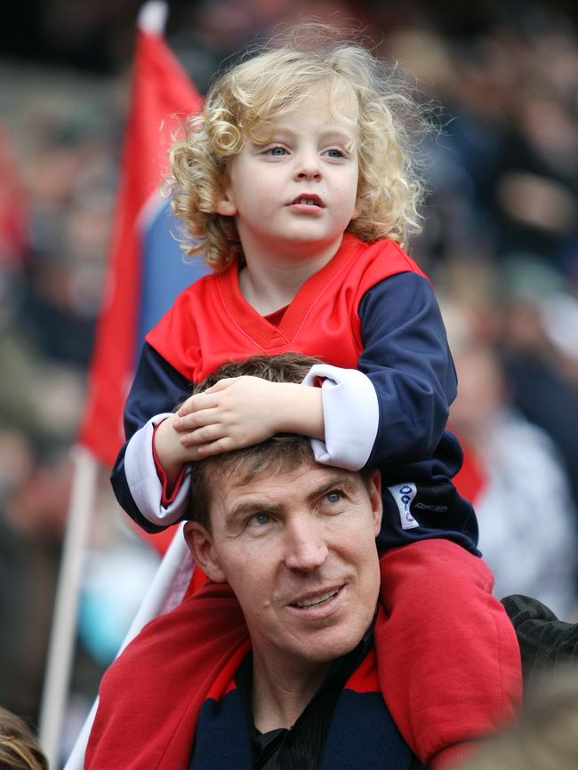 Jim Stynes and his son Tiernan during the 150th anniversary parade at the MCG.