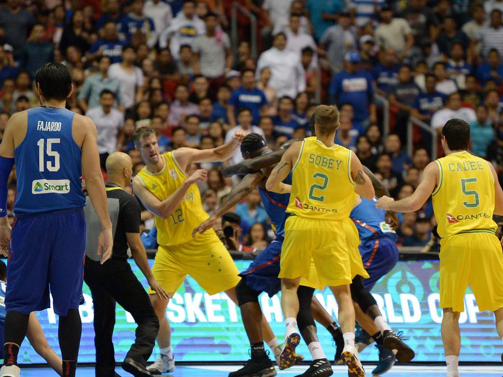 Philippine and Australian players engage in a brawl during their FIBA World Cup Asian qualifier game at the Philippine arena in Bocaue town, Bulacan province, north of Manila on July 2, 2018. Australia won by default 89-53. / AFP PHOTO / TED ALJIBE