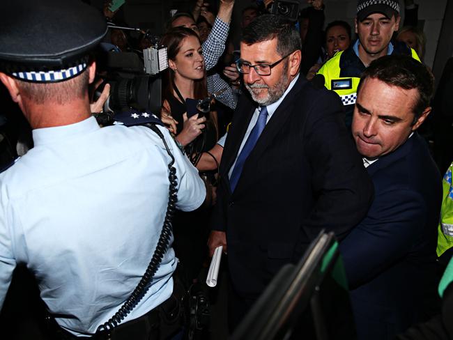 Ben McCormack (far right) leaves Redfern Police station after being given bail. Picture: Adam Yip