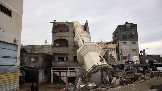 Palestinian women walk near a fallen minaret of a destroyed mosque during the Muslim holy fasting month of Ramadan, in the Nuseirat refugee camp in the central Gaza Strip. Picture: AFP