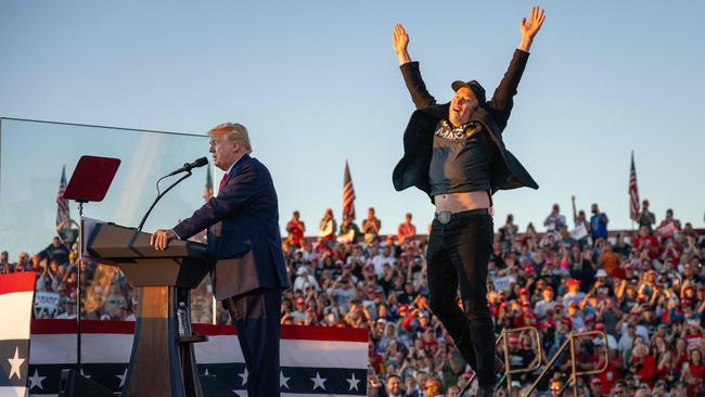 Elon Musk, right, joins Donald Trump on stage at a campaign rally in October. Picture: AFP