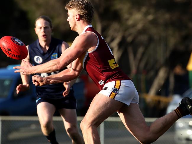 Tom Keys fires off a handball against Epping last season. 