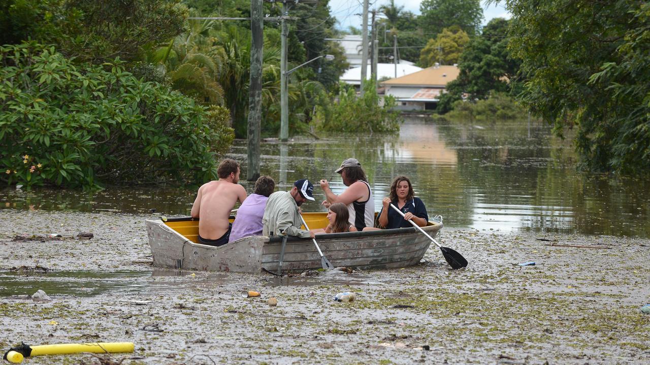 People in a boat negotiate flood water and debris in Bundaberg, Queensland, Monday, Jan. 28, 2013. At least 1200 Bundaberg properties are already flooded, and there are fears that could reach 2000. (AAP Image/Dan Peled) NO ARCHIVING