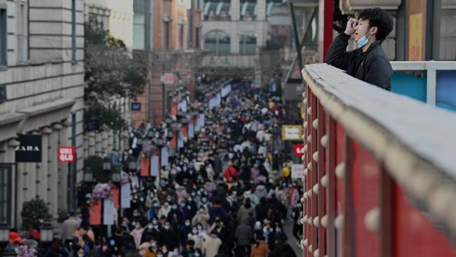 A man looks over thousands of shoppers in Wuhan on Friday. Picture: AFP