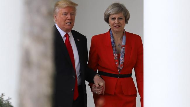 British Prime Minister Theresa May helps US President Donald Trump with his fear of stairs. Picture: Christopher Furlong/Getty Images