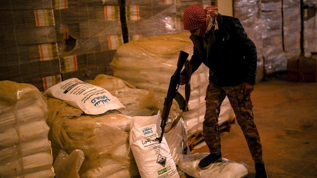 Syrian rebel fighters inspect sacks marked to contain "Saudi-made" flakes of caustic soda at a drug manufacturing facility. Picture: AFP