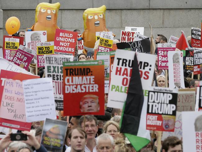 The protests featured milkshakes to throw at effigies of Mr Trump, a fake wall and a ‘Dumping Trump’ robot. Picture: AP Photo/Tim Ireland