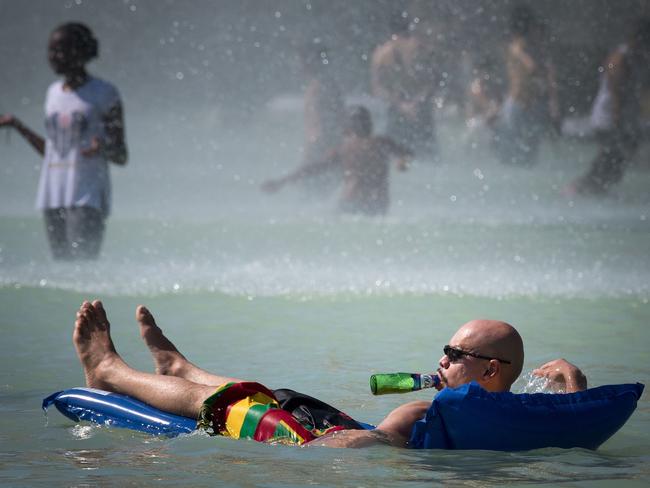 People cool themselves at The Trocadero Fountain in Paris. Picture: Gerard Julien