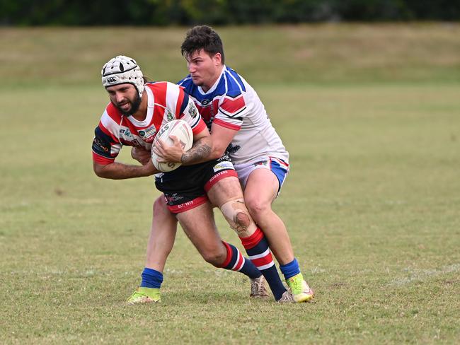 Atherton’s Willem Foster is wrapped up by an Ivanhoe Knights defenders. Picture Emily Barker.